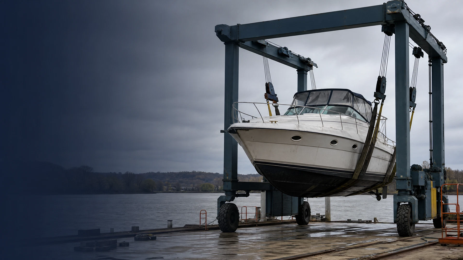 Marine crew carefully handling a boat recovery beside a working river dock